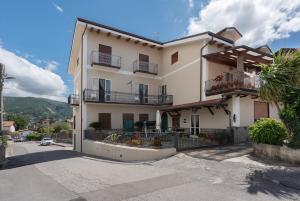 a large white building with balconies on a street at Residence Sulla Costa in Agerola