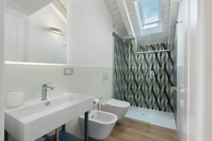 a white bathroom with a sink and a toilet at Residence Sulla Costa in Agerola +56 photos