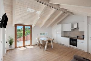 a kitchen and dining room with a table and chairs at Residence Sulla Costa in Agerola