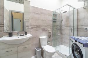 a bathroom with a toilet and a sink and a shower at Le Quattro Perle Apartments in Pachino +69 photos