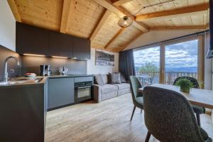 a kitchen and living room with a couch and a table at Chalet Schlossberg Schwarzhorn in Nova Ponente