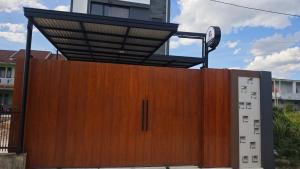 a wooden door with a roof on top of it at AIRO Villas in Sultan Syarif Kasim II International Airport