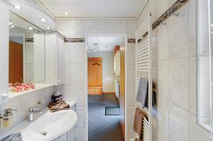 a bathroom with a sink and a mirror at Ferienwohnung Härtel in Bad Zwischenahn +31 photos