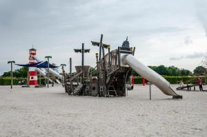 a playground with a slide in the sand at Fewo3 Buppeape Saterland in Bollingen