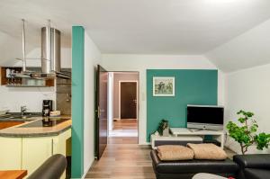 a kitchen and living room with a couch and a table at Fewo3 Buppeape Saterland in Bollingen
