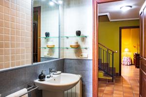 a bathroom with a sink and a mirror at Casa Rural Doña Manuela in Valdemierque +27 photos