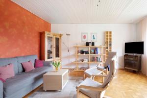 a living room with a couch and a tv at Bikerhäusle in Gerstetten