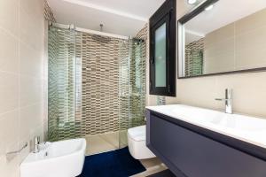a bathroom with a sink and a toilet and a mirror at Villa La Primera in Llucmajor +17 photos