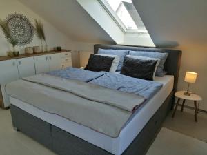 a bedroom with a large bed with a skylight at Ferienwohnung Romanu in Winzeln