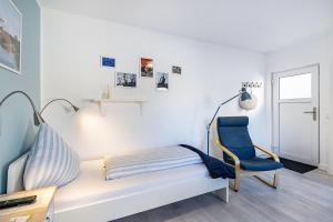 a living room with a couch and a blue chair at Friesenstube in Kerken
