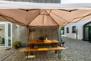 a picnic table under a tent on a patio at Friesenstube in Kerken