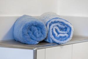 a pair of blue towels sitting on a shelf at Friesenstube in Kerken +13 photos