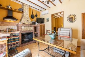 a living room with a table and a fireplace at Lavanda in Hinojares