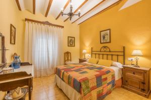 a bedroom with a bed and a piano at Lavanda in Hinojares