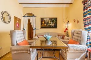 a living room with a table and two chairs at Lavanda in Hinojares +27 photos