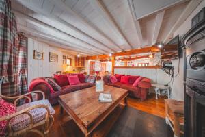 a living room with a couch and a table at Le Cottage des Pléiades in Les Angles
