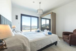 a bedroom with a bed and a large window at Villa Bumortu in Olmeto