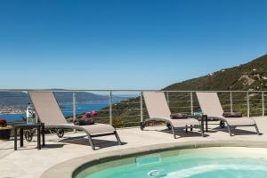 a patio with chairs and a swimming pool with a view at Villa Bumortu in Olmeto