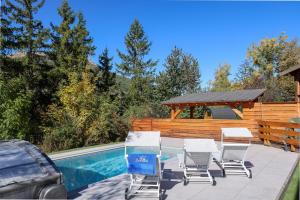 a patio with a table and chairs next to a pool at Laltizoard in Briançon