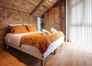a bedroom with a large bed with wooden walls at Laltizoard in Briançon +25 photos