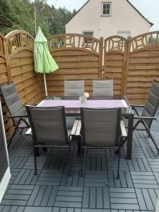 a patio with a table and chairs and an umbrella at Garten der Ruhe in Osterbuch
