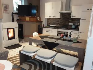 a kitchen with a table and chairs and a fireplace at Garten der Ruhe in Osterbuch