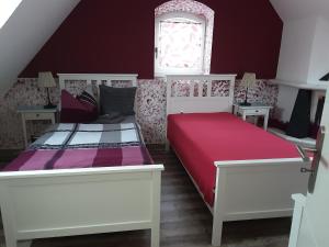 a bedroom with two beds and a window at Garten der Ruhe in Osterbuch +4 photos