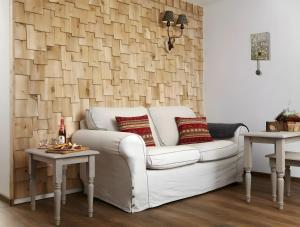 a living room with a white couch and two tables at Hotzenwald in Ibach