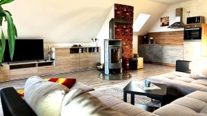a living room with a couch and a fireplace at Ferienglück Goldach in Hallbergmoos