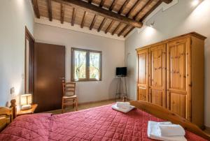 a bedroom with a large bed and a window at Faetino - Gallo in Colle di Val d'Elsa +15 photos