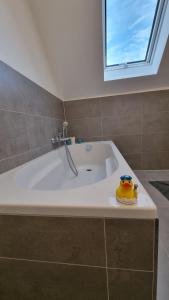 a bathroom with a tub with a rubber duck on it at Ferienglück Goldach in Hallbergmoos