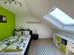a bedroom with a bed with a green wall at Hegaublick in Stockach