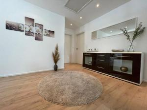 a living room with a large room with a rug at Hegaublick in Stockach +7 photos