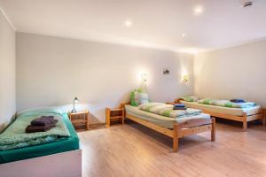 a room with two beds and two tables in it at Fewo Heimathafen in Osterbruch