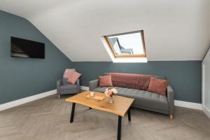 a living room with a couch and a table at Ocean Breeze Apt 3 in Dunfanaghy
