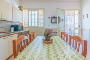a kitchen with a table with a potted plant on it at Casa Nico in Augusta