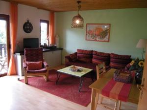 a living room with a couch and a table at Rhön Residence in Dipperz