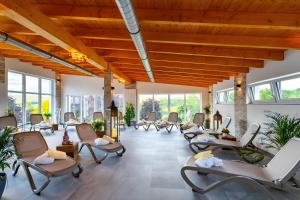 an empty waiting room with chairs and windows at Rhön Residence in Dipperz