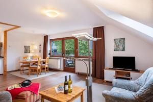 a living room with a couch and a table at Ferienhaus Völkle in Hinterzarten