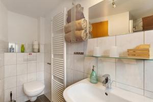 a white bathroom with a toilet and a sink at Pension Neuenrade in Neuenrade +53 photos