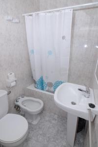 uma casa de banho com um WC, um lavatório e um chuveiro em Hostal Rosalia em San Antonio