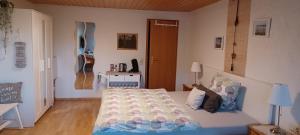 a bedroom with a bed and a guitar on the wall at Ferienunterkünfte Schüle in Leibertingen