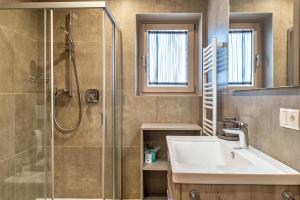 a bathroom with a sink and a shower at Aster Moments Apt Moritz in San Genesio Atesino