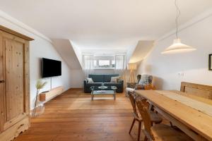 a living room with a table and a couch at Apartment Weingut Zail in Appiano sulla Strada del Vino