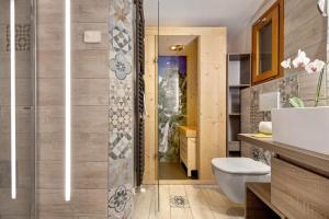 a bathroom with a shower and a toilet and a sink at Ciarii Holiday Homes in Tremosine Sul Garda +41 photos