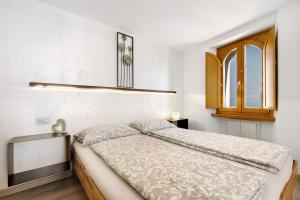 a bedroom with a bed and a window at Ciarii Holiday Homes in Tremosine Sul Garda