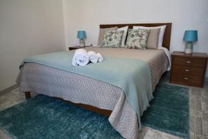 a bedroom with a bed with two towels on it at Casa Pedra da Paciência in Monsanto +5 photos