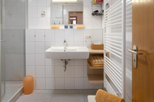 a white bathroom with a sink and a mirror at Ringlihof in Horben +51 photos