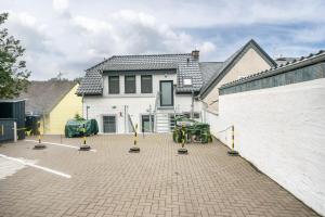 a house with a parking lot in front of it at Ferienwohnung Maxim in Saarburg
