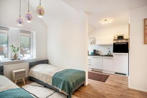 a bedroom with a bed and a kitchen at Ferienwohnung Maxim in Saarburg
